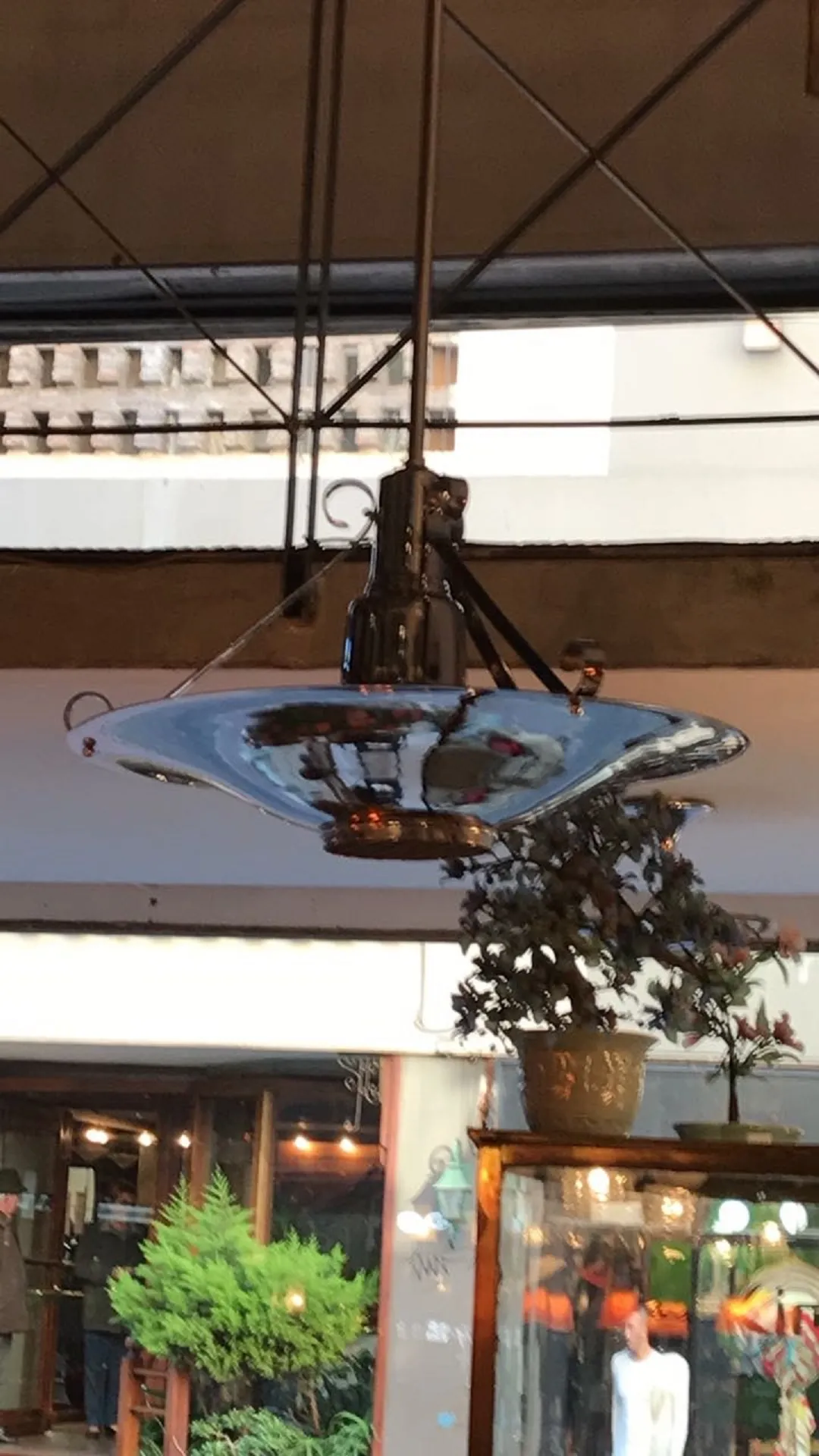 Antique hanging lamp with bright, intricate details.