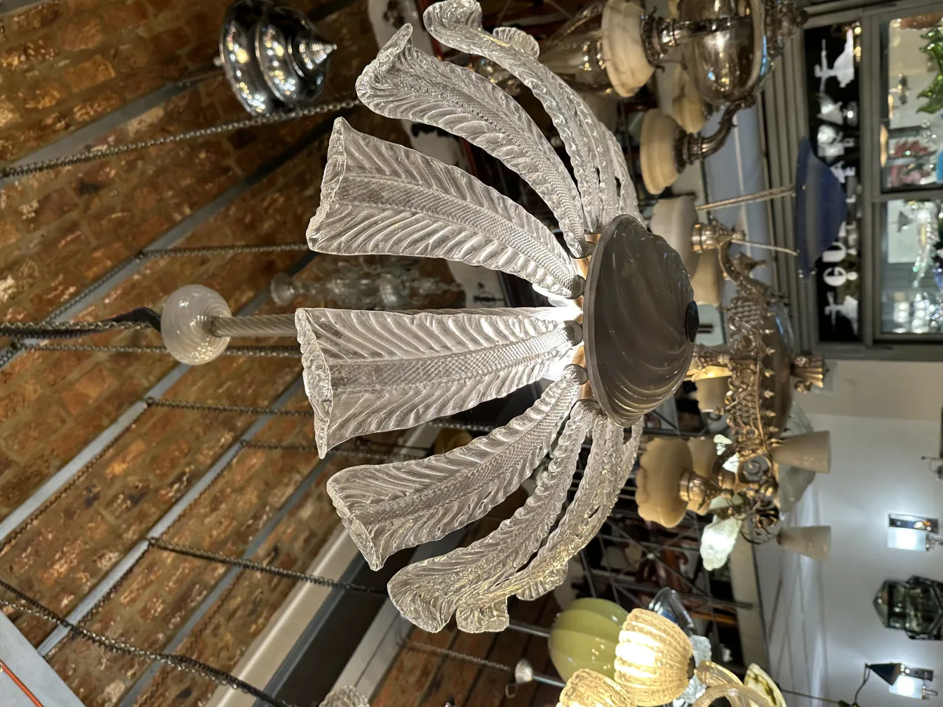 Antique hanging lamp with an intricate design, illuminating a cozy setting.