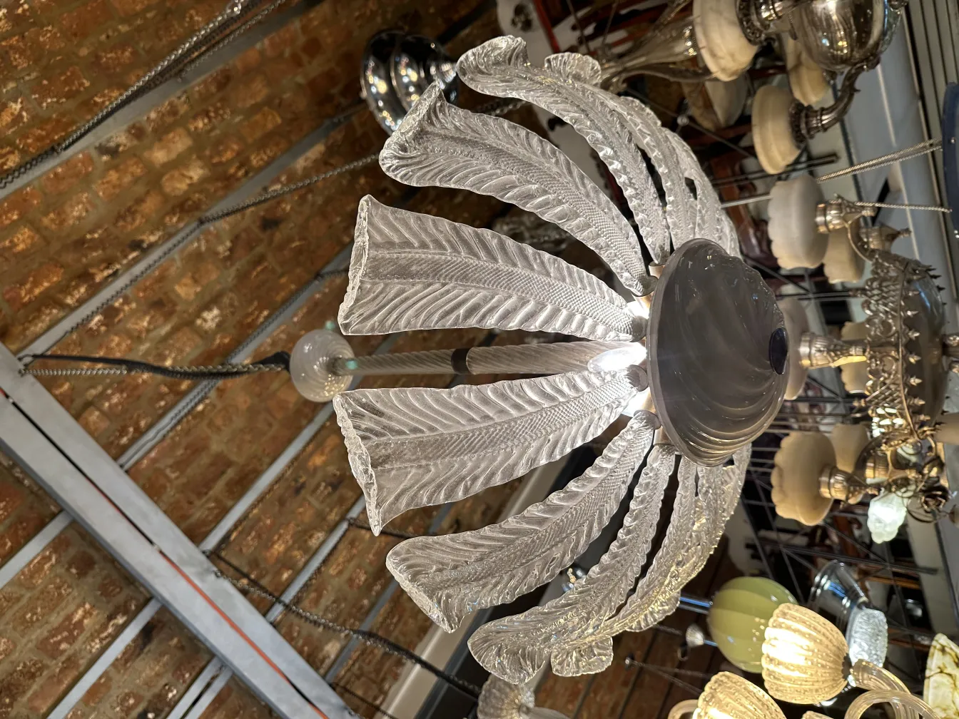 Antique hanging lamp with leaf design in a workshop