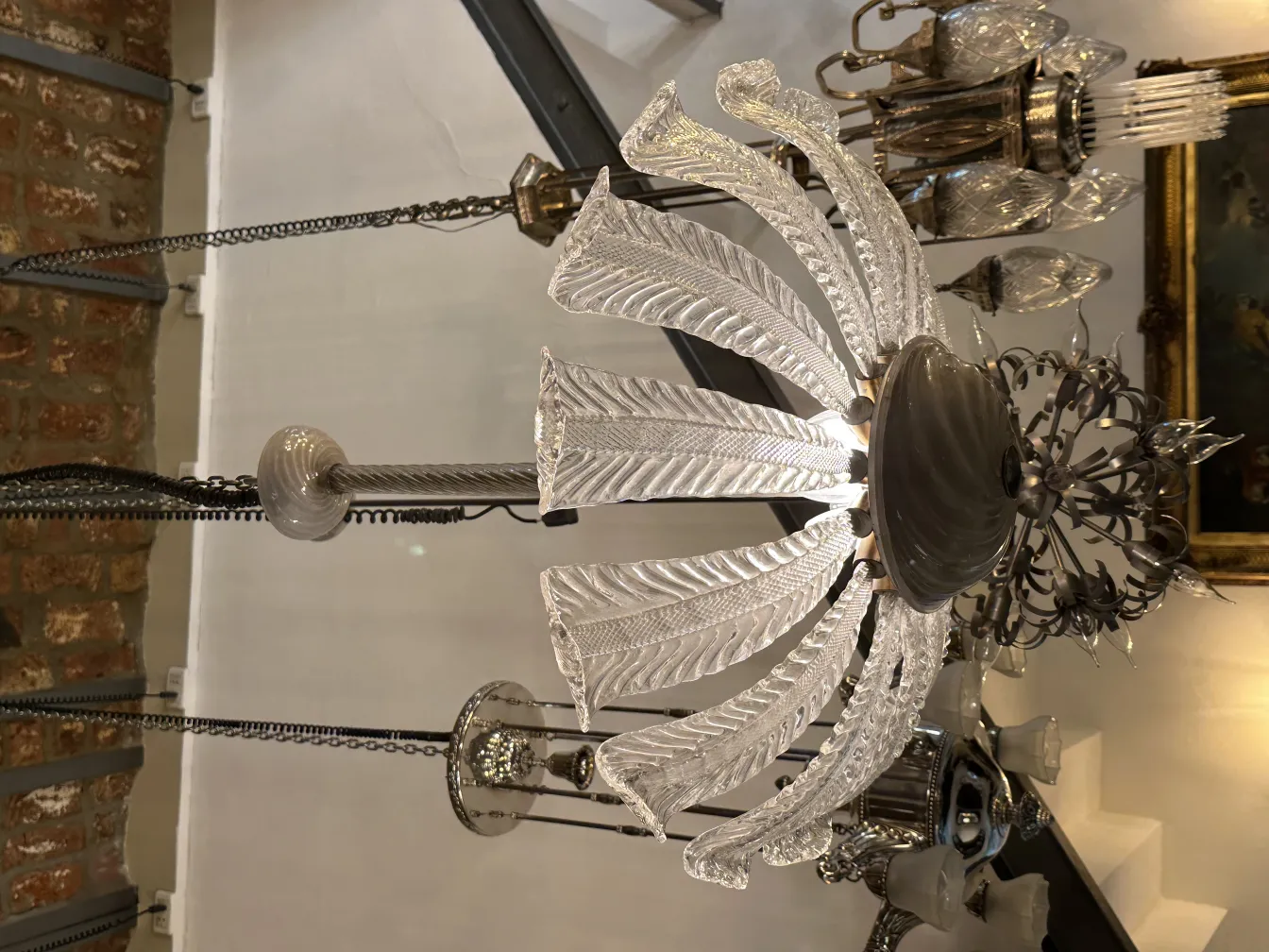 Antique hanging lamp with glass and metal details in a cozy setting.