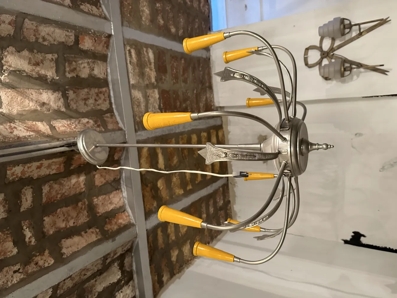 Antique hanging lamp featuring yellow shades in a rustic setting.