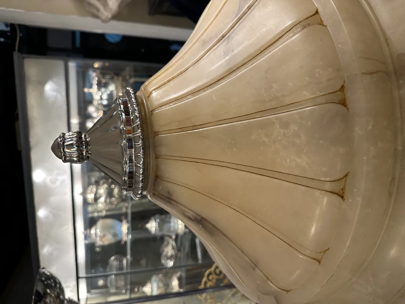 Antique hanging lamp with elegant design, shiny details in a decorative setting.