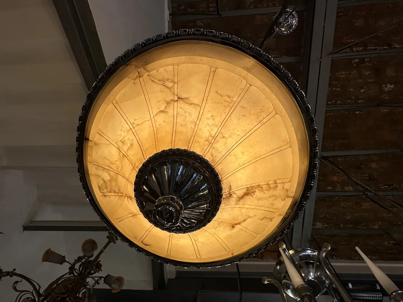 Antique hanging lamp with an elegant design, providing warm light in a cozy environment.