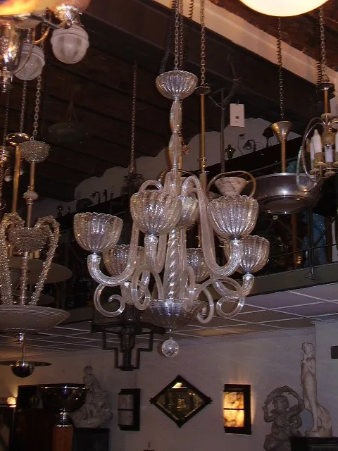 Antique hanging lamp with crystal details, suspended in an elegant setting.