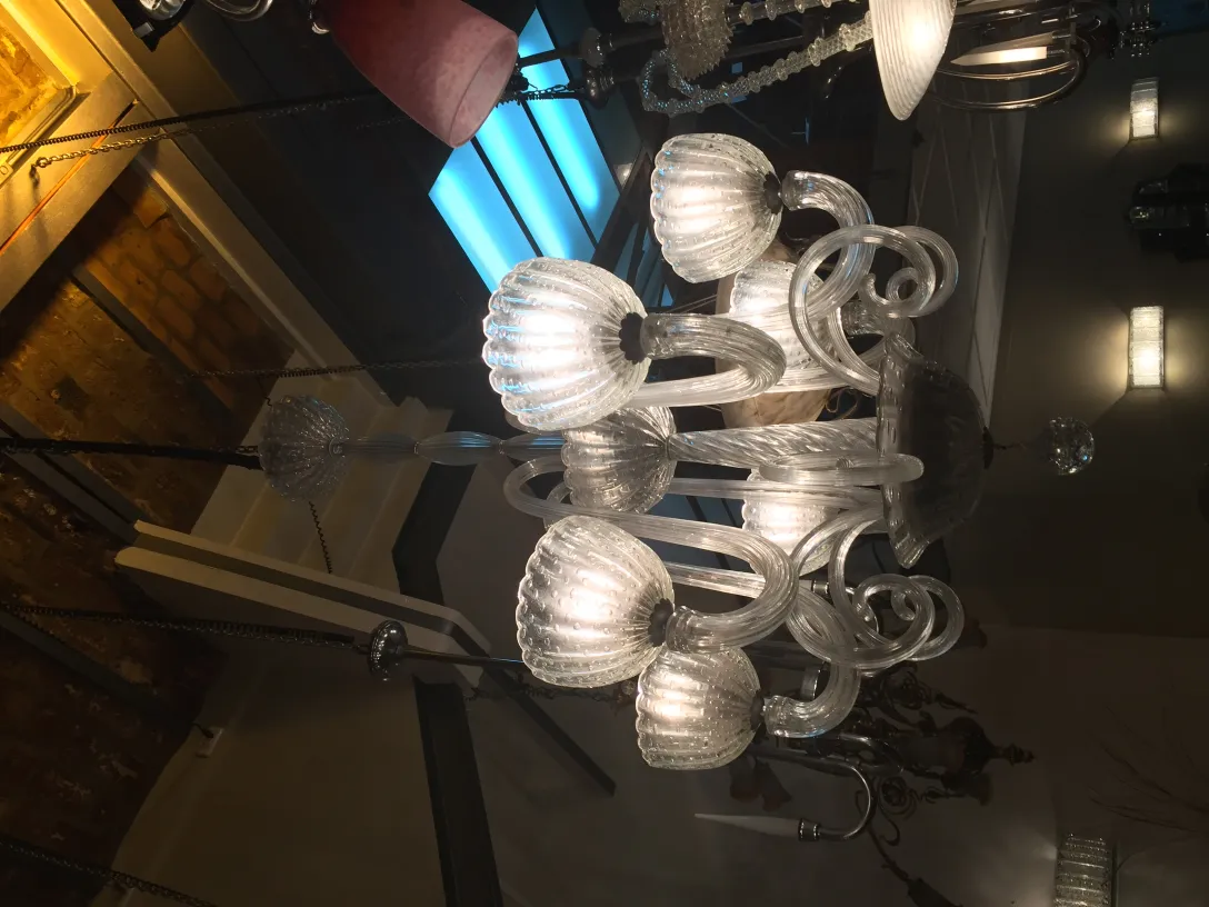 Antique hanging lamp made of transparent glass with elegant details, illuminating the space.