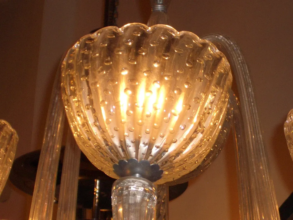 Lustre ancien avec détails en verre et lumière chaude.