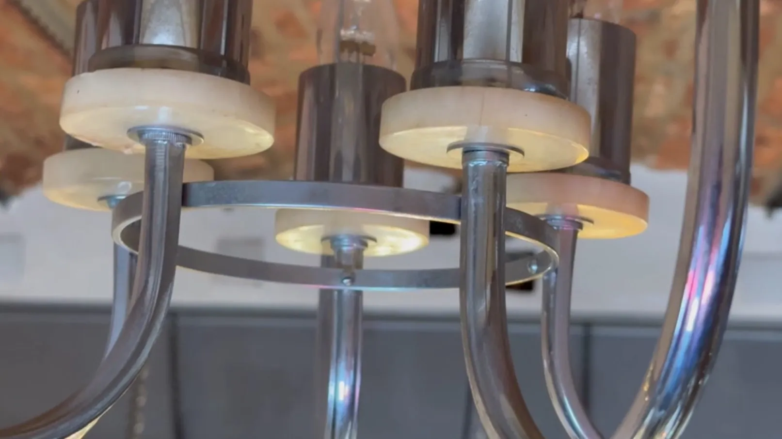 Lámpara de techo antigua con luces en un entorno acogedor.