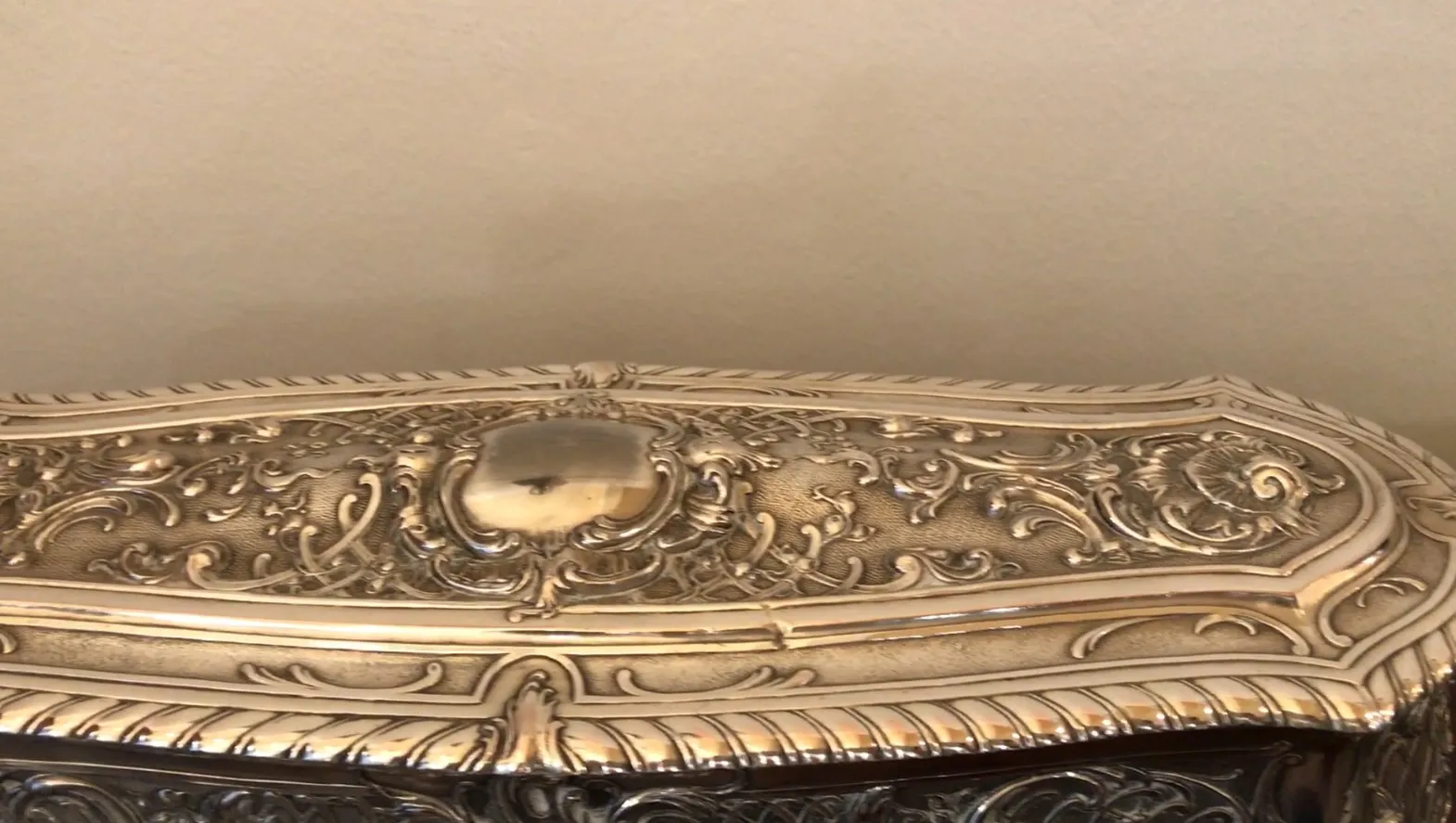 Antique box featuring beautiful embossed design and intricate details.