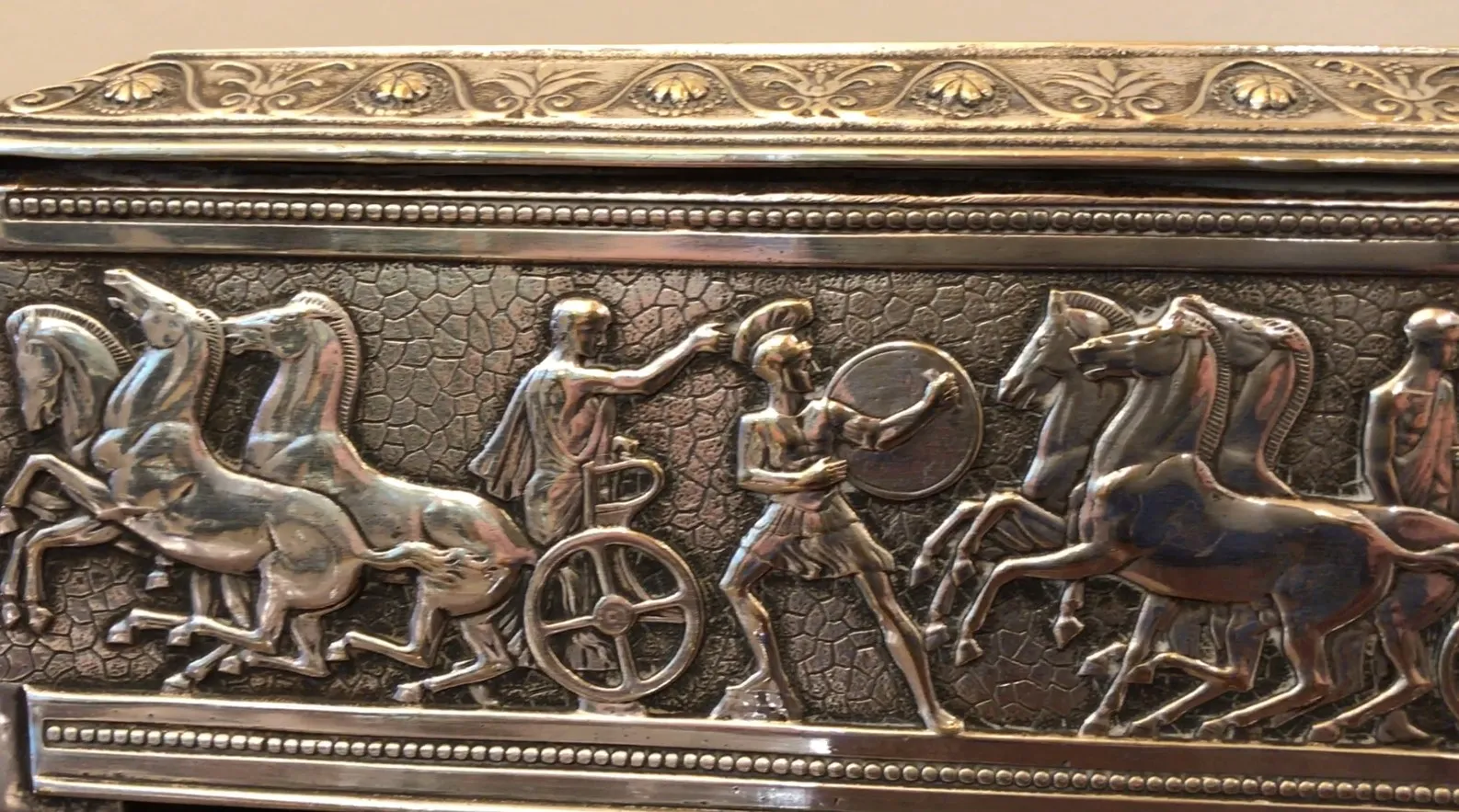 Antique box decorated with reliefs of historical scenes, perfect for collectors.
