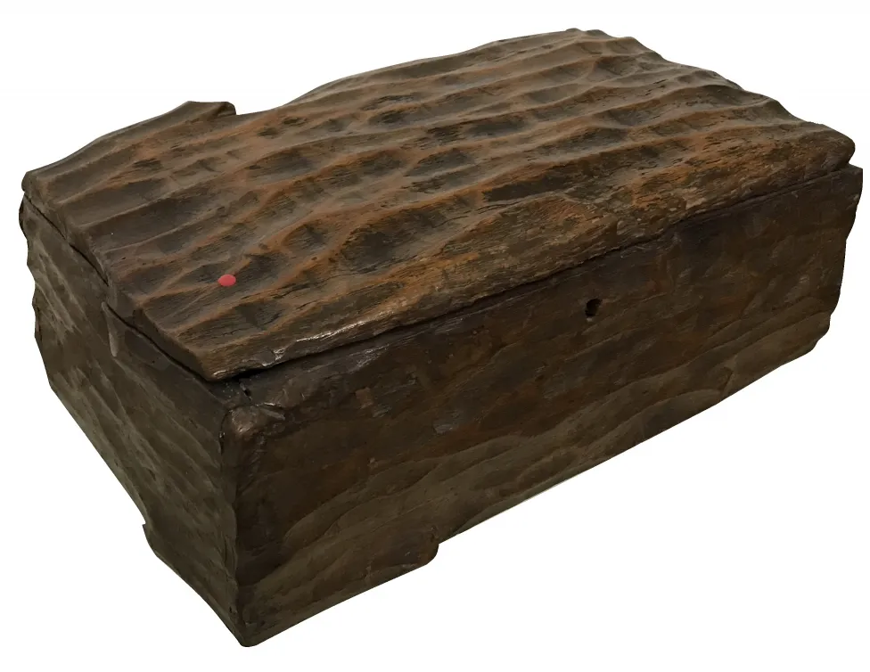 Antique wooden box with a rough texture and lid detail