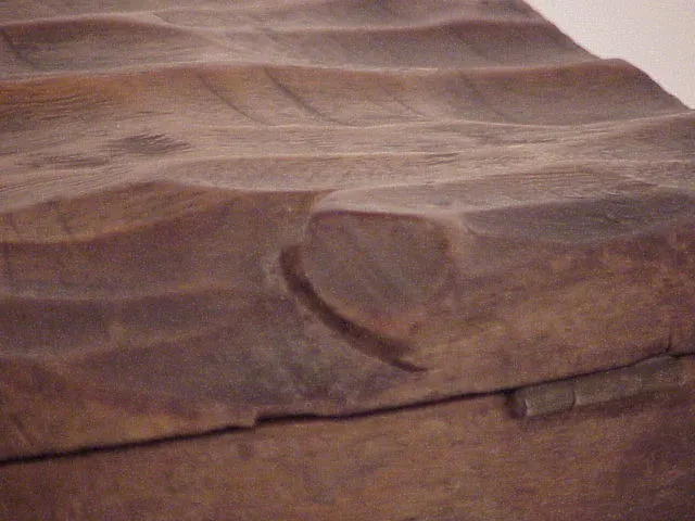 Antique wooden box with carved design and natural texture