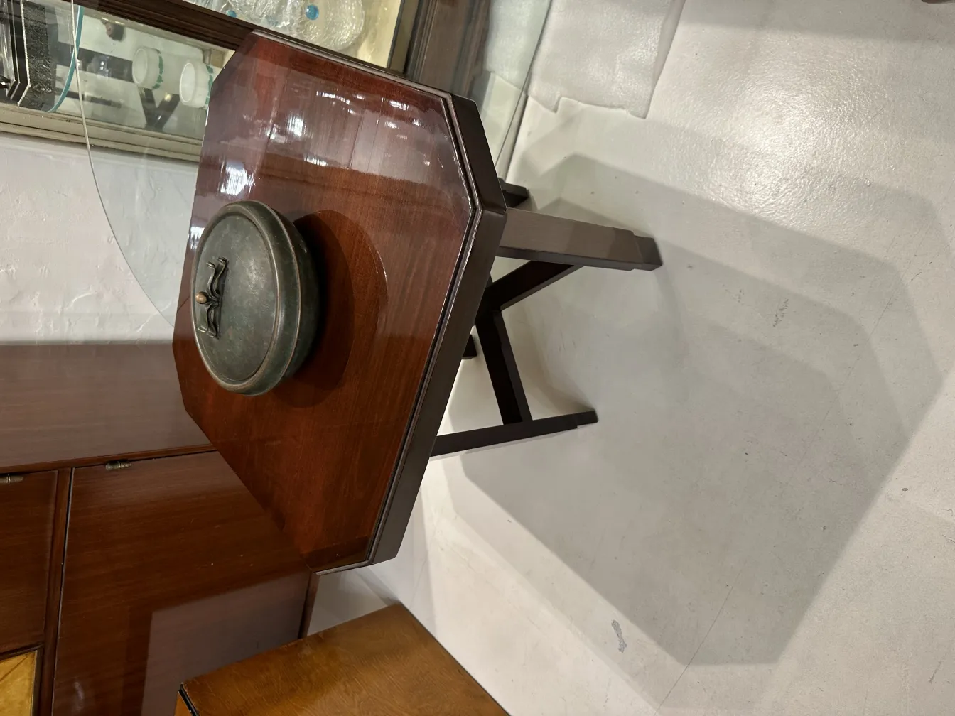 Antique wooden box with round lid on table.