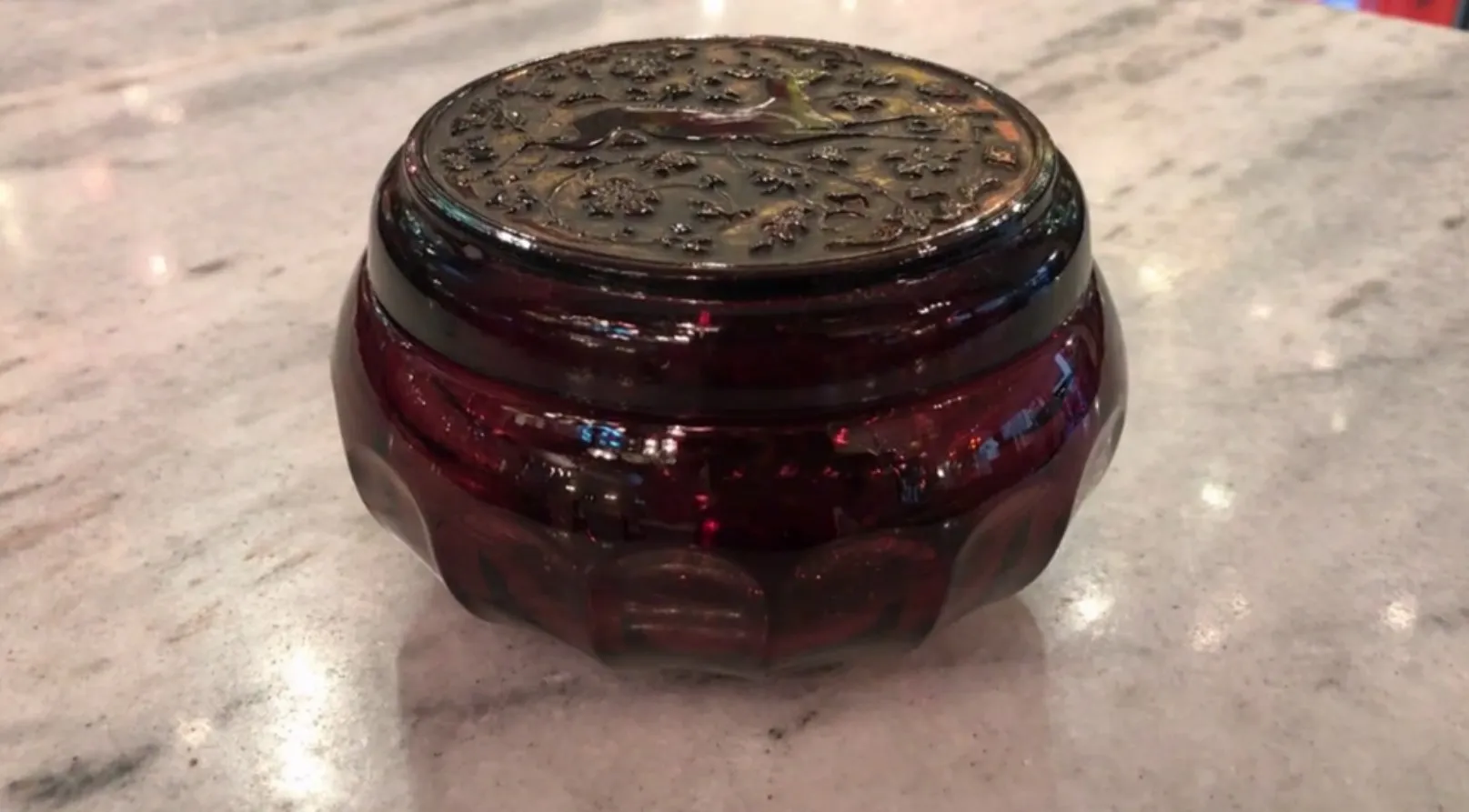 Antique red glass box with a decorative lid