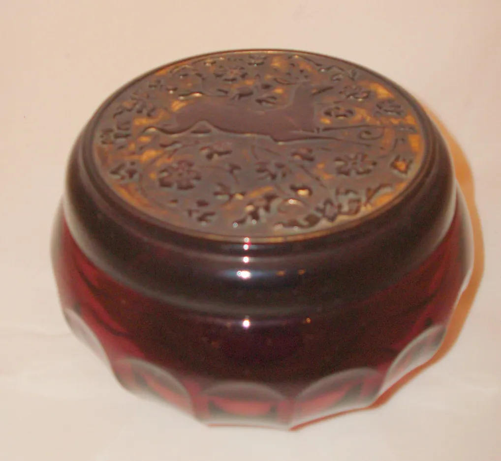 Antique glass box with decorative relief lid.