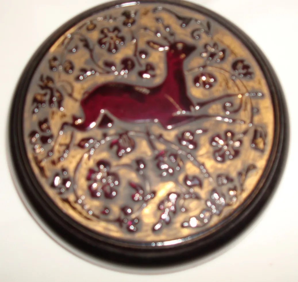 Antique box featuring a carved deer on top, floral designs