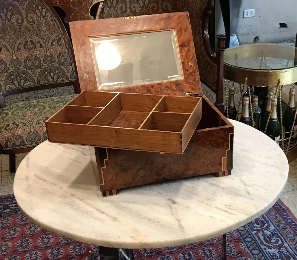 Antique wooden box with dividers and glass lid.