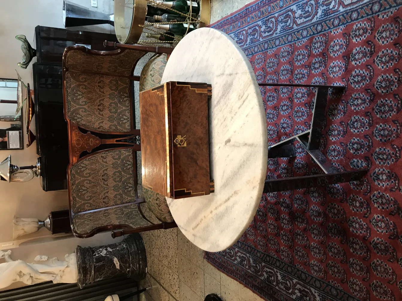 Antique box on marble table in elegant setting.