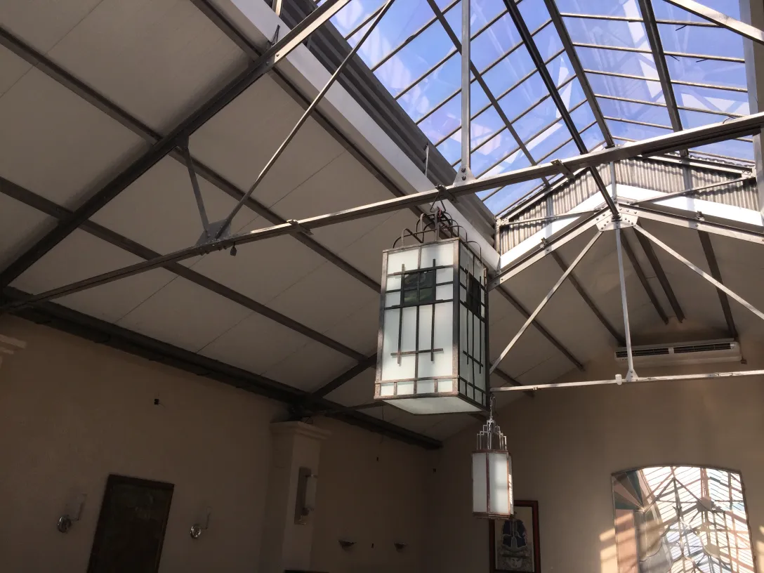 Two antique lanterns with elegant design in a cozy setting.