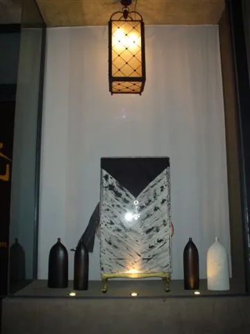 Two antique lanterns in an elegant setting with decorative items.