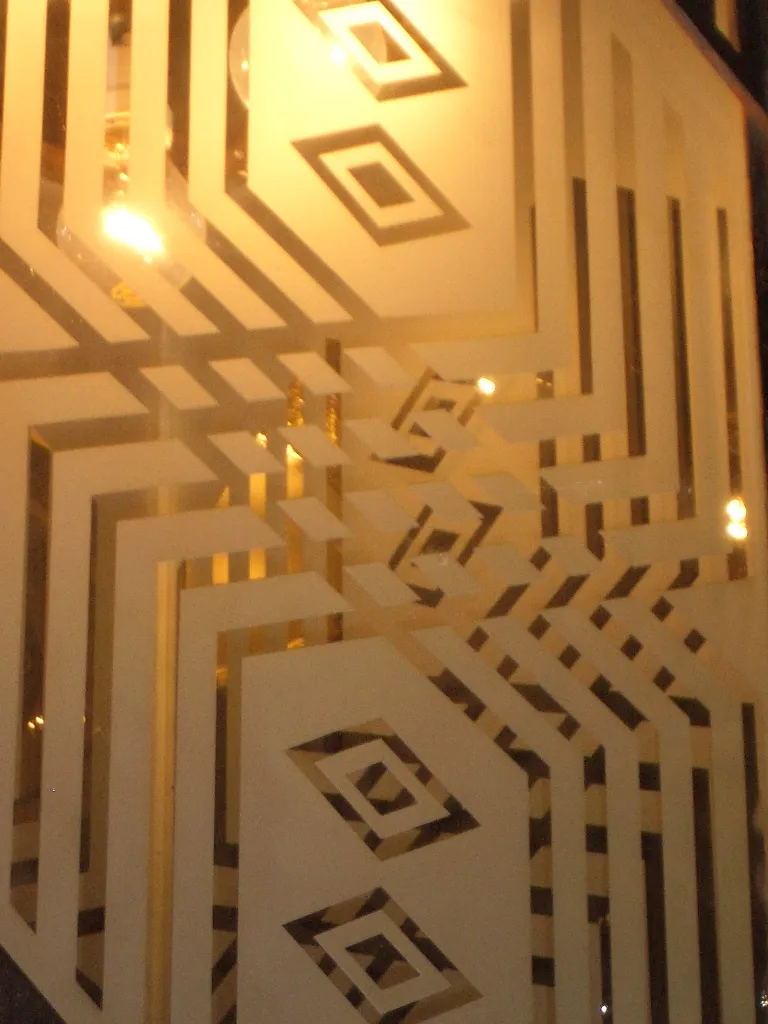 Two antique lanterns featuring a geometric design, beautifully lit.