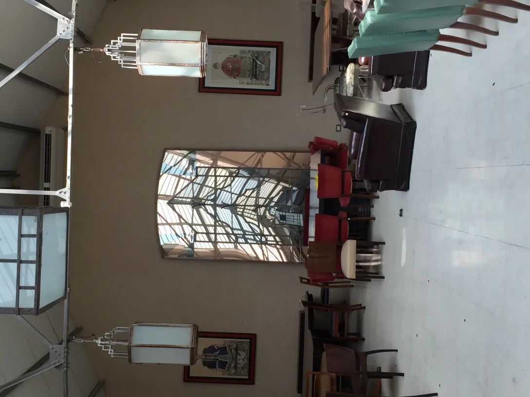 Escena interior con dos faroles antiguos colgando y una decoración elegante.