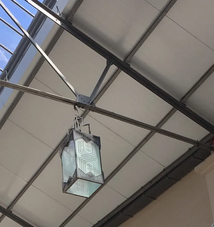 Two antique hanging lanterns with elegant design and artistic details in a modern setting.