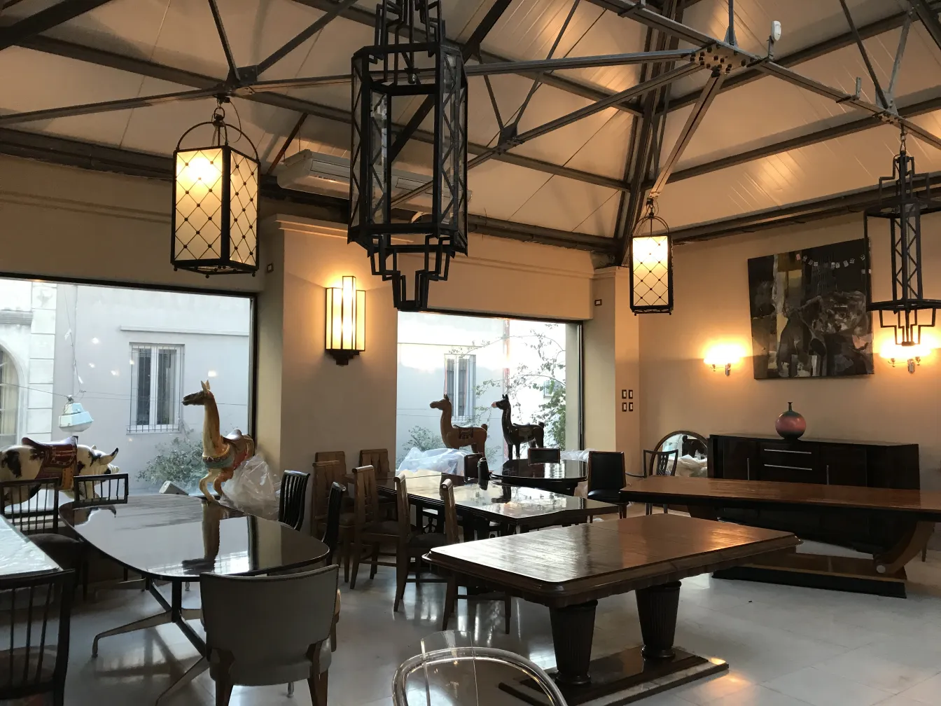 2 antique lanterns hanging in an elegant environment with furniture.