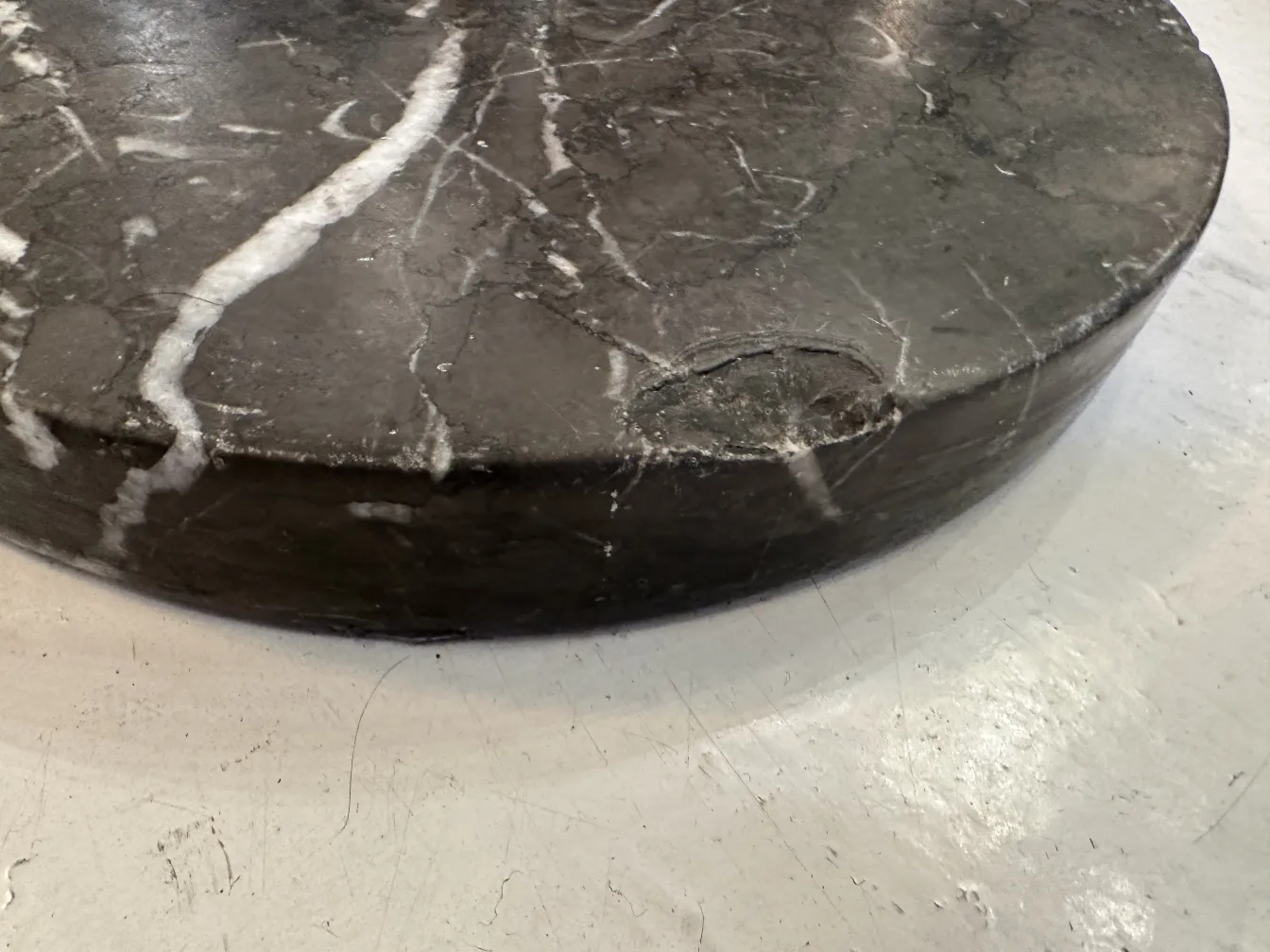 Antique champagne cooler with an elegant dark marble design.