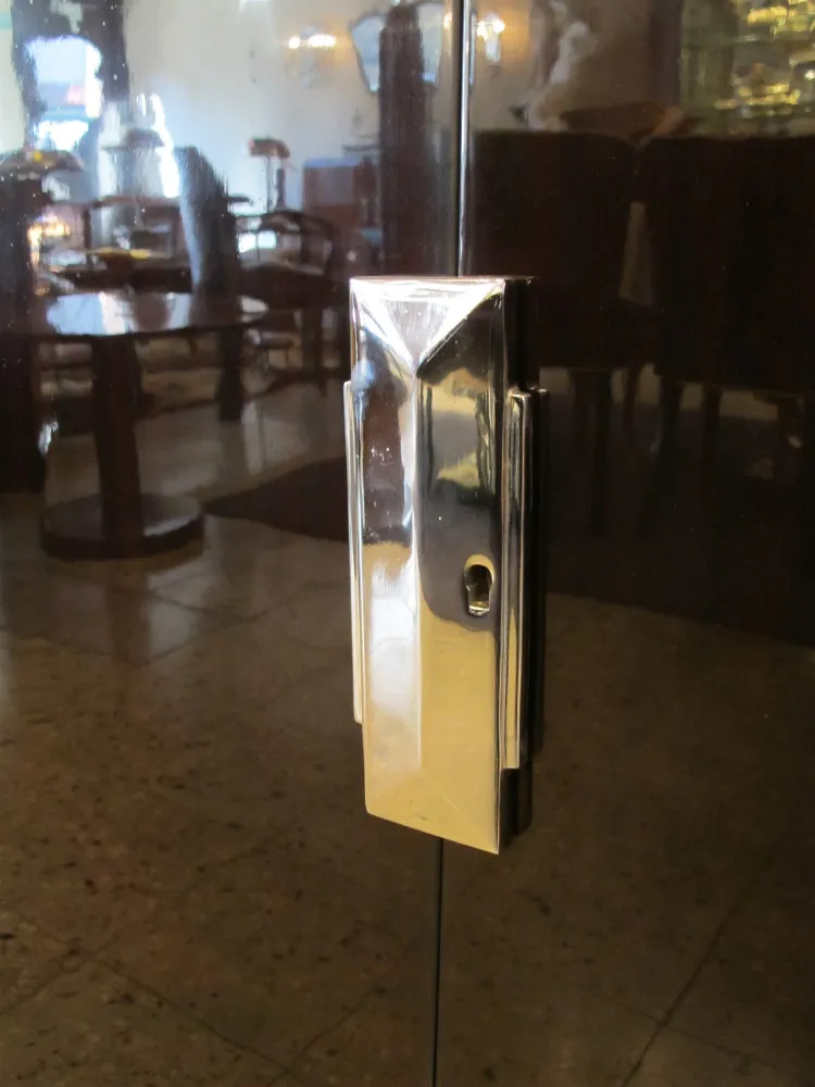 Cerca de un aparador antiguo con un acabado brillante, en un ambiente elegante.