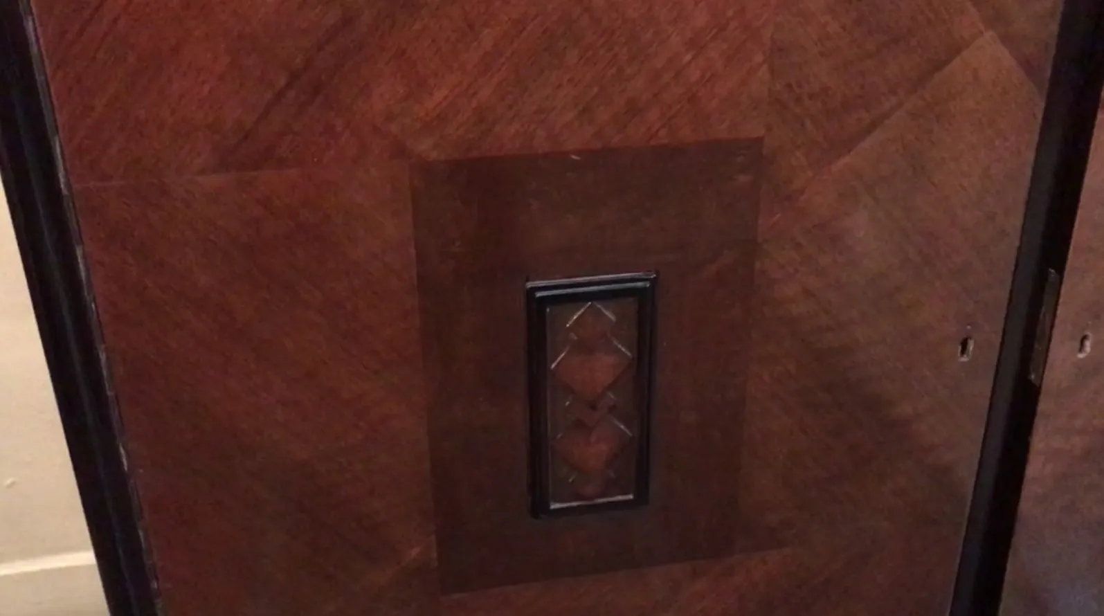 Antike Anrichte mit dekorativen dunklen Tönen und elegantem Design.