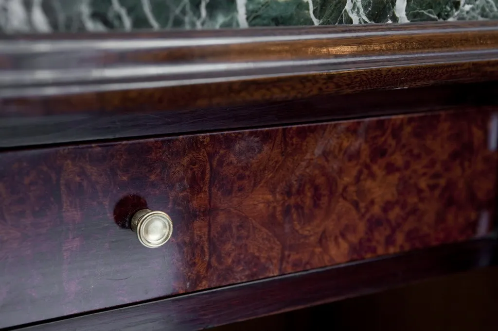 Antique sideboard with intricate detailing, perfect for classic interiors.