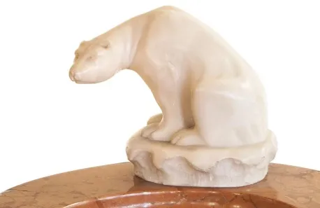 Antique standing ashtray with a bear figure on a round base, featuring subtle decorative details.