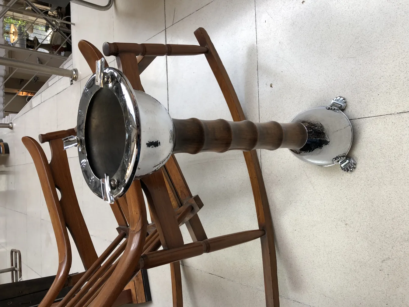 Standing ashtray with decorative base and match holder, set with wooden chairs