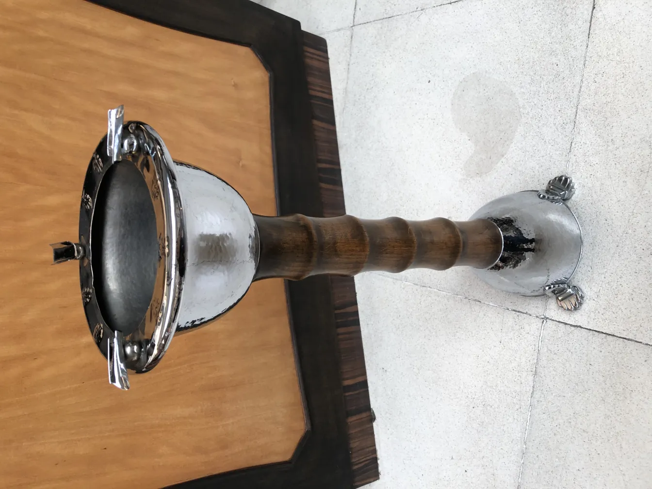 Antique standing ashtray with decorative details at the base, ideal for elegant settings.