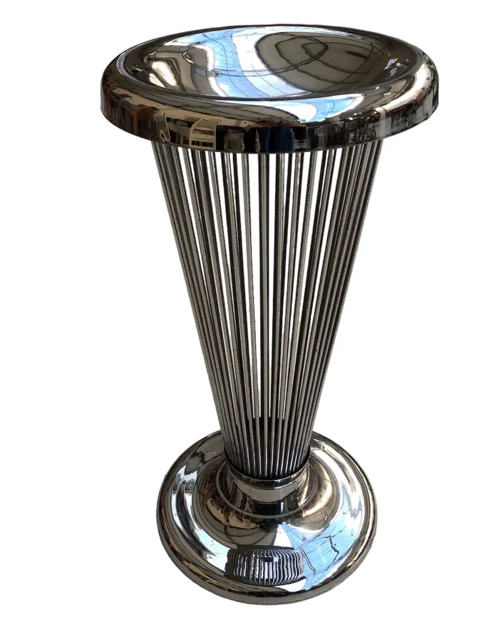 Antique standing ashtray with a shiny and elegant finish, in a sophisticated setting.