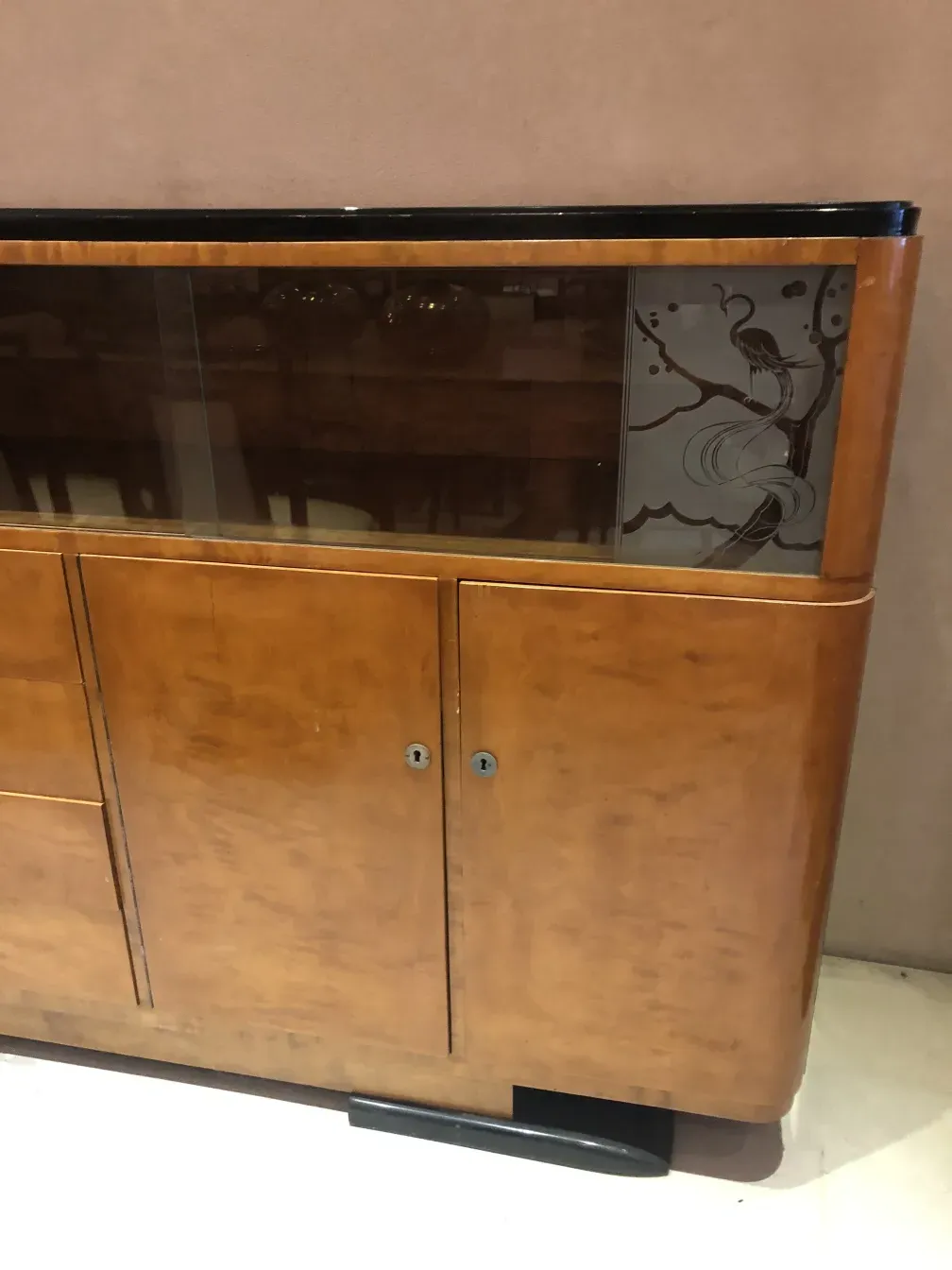 Antique bookcase with glass doors, elegant design.
