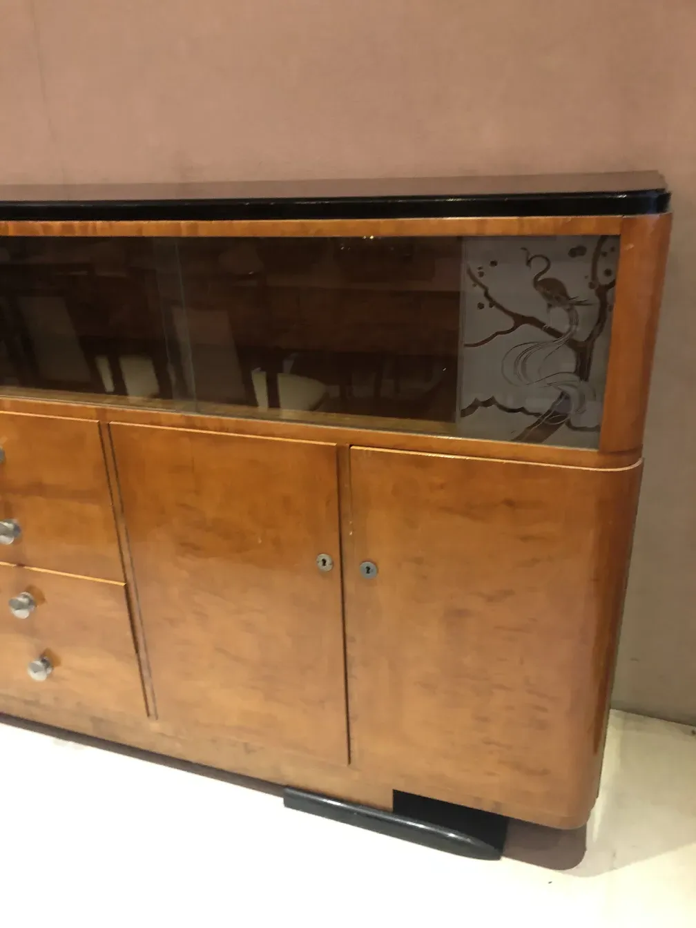 Antique bookcase featuring glass details on the door, stylish and practical.