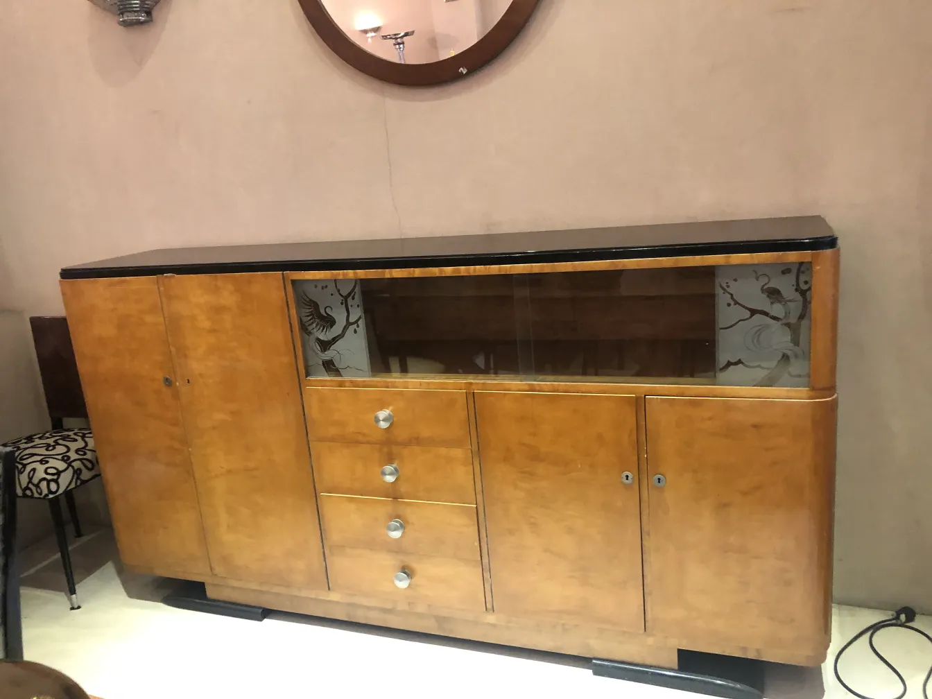 Antique bookcase featuring glass shelves and subtle decorations.
