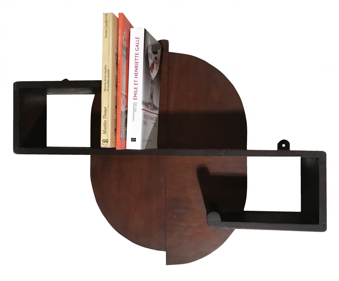 antique bookcase featuring books of different colors and styles, decorative elements