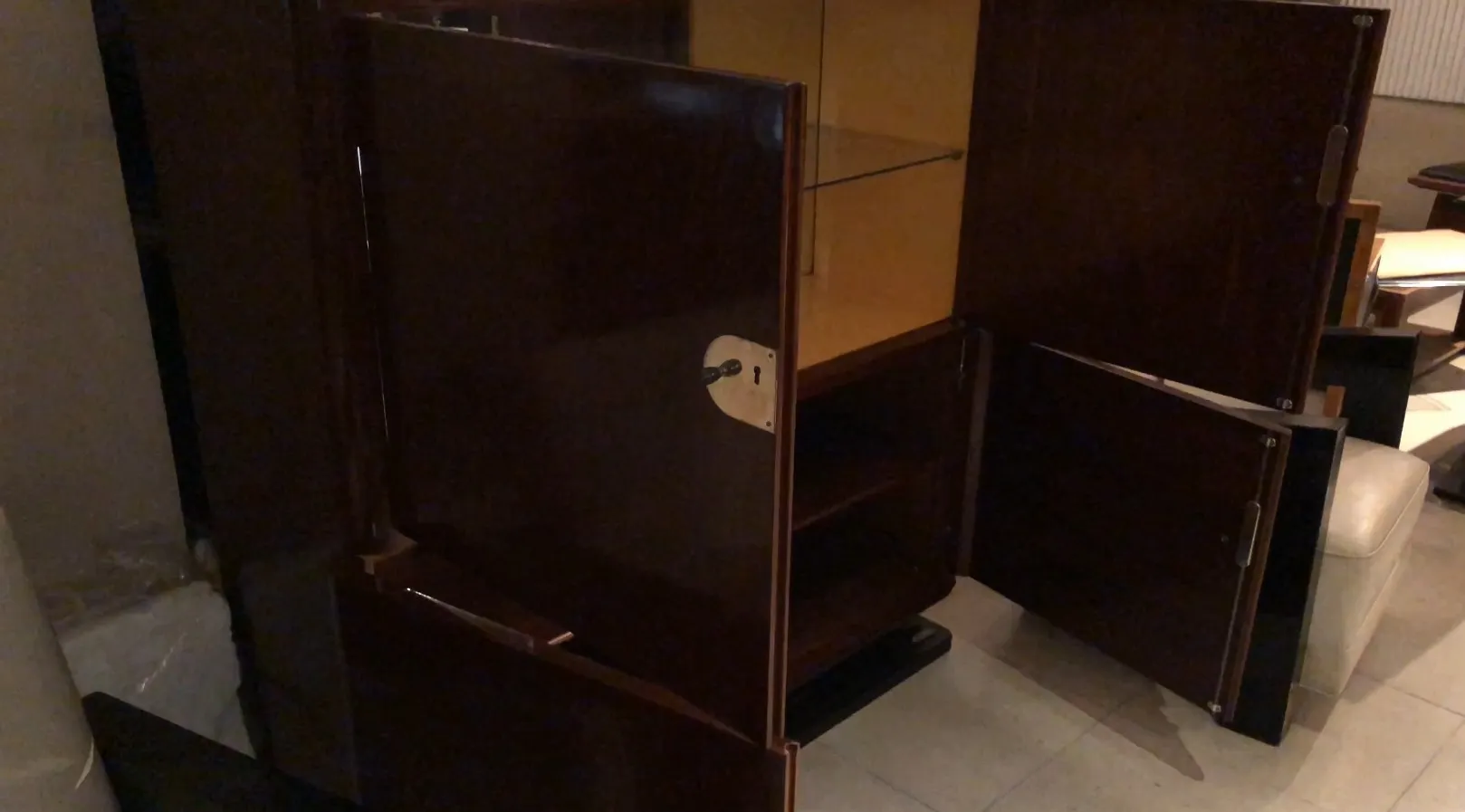 Bibliothèque ancienne avec portes en bois et étagères internes, dans un cadre accueillant.