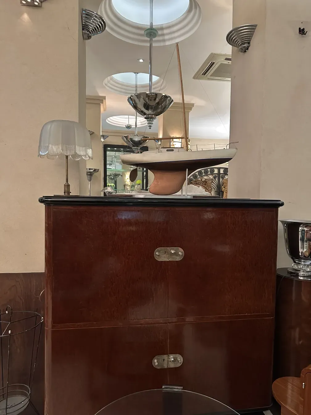 Libreria antica con finiture classiche e atmosfera elegante. Dettagli decorativi e luce soffusa.