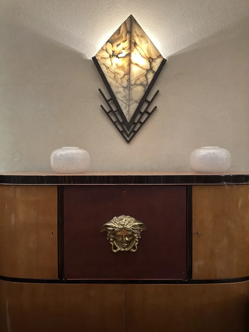 Antique bookcase with unique design, elegant decorations, and soft lighting.