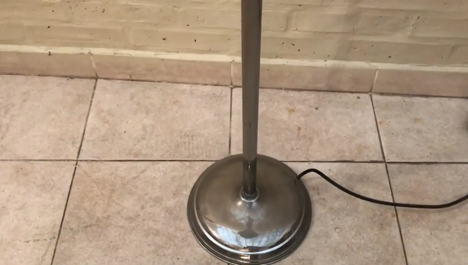 antique floor lamp with round base in a cozy setting.