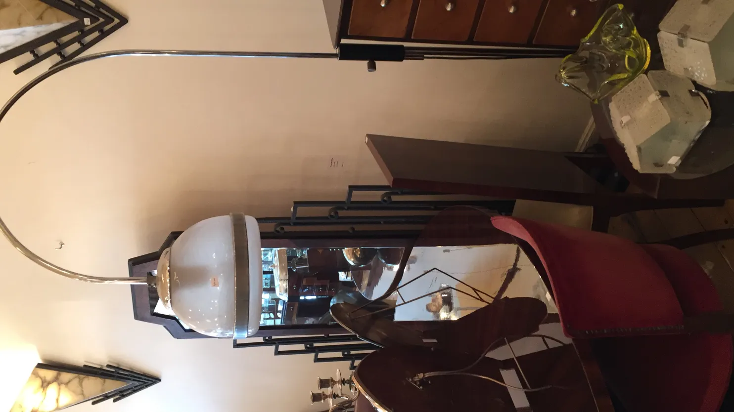 Lampada da terra antica con design curvo ed elegante, atmosfera accogliente, elementi decorativi sullo sfondo.