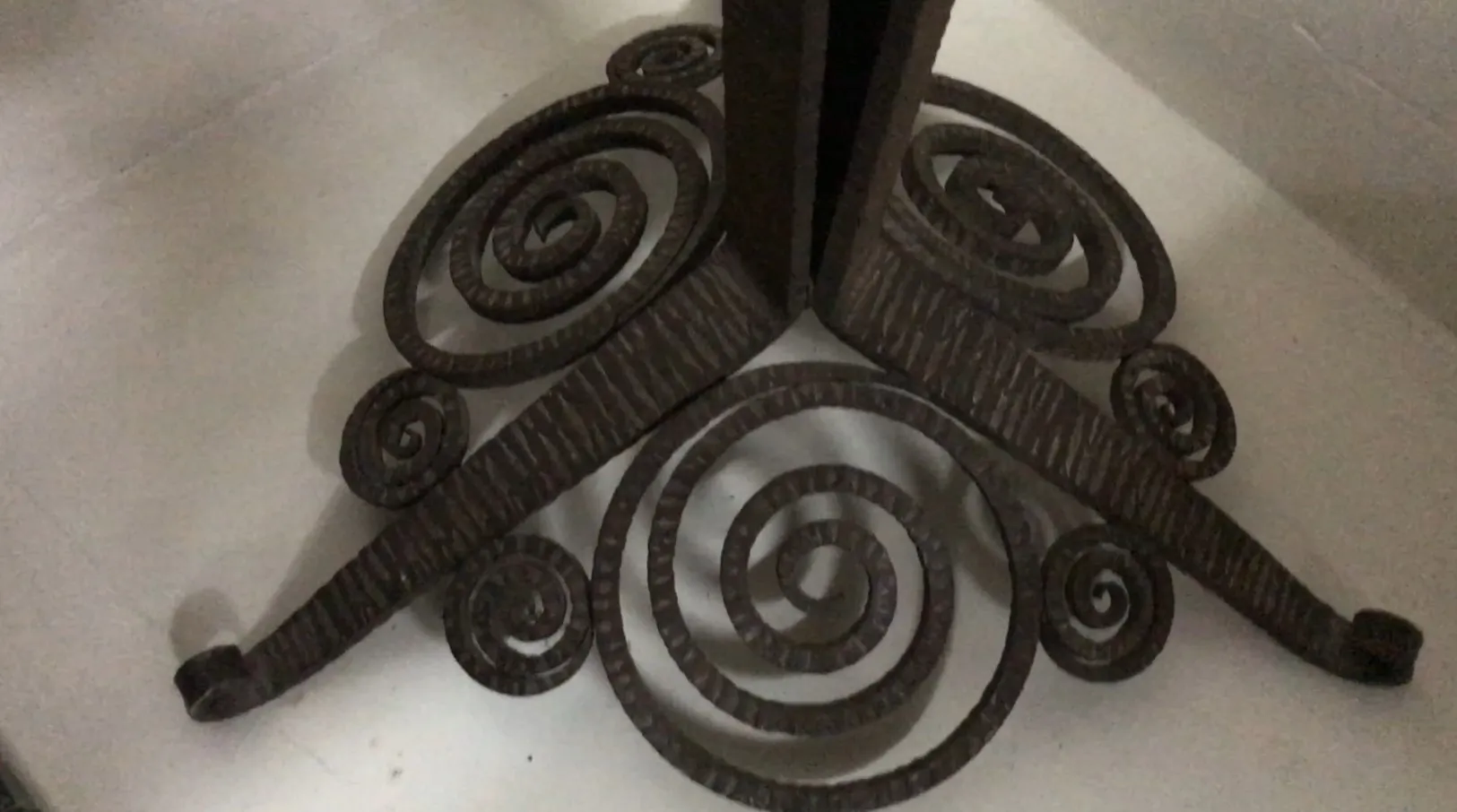 Antique floor lamp base with decorative spirals.