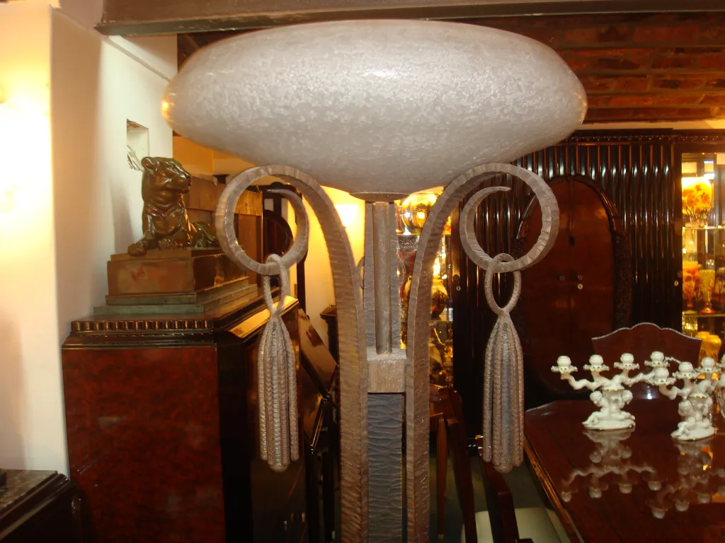 Antique floor lamp with decorative base and elegant details in indoor setting.