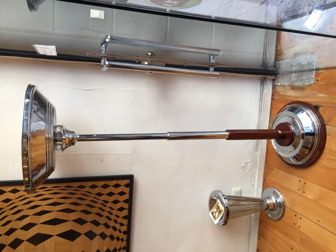 Antique floor lamp with elegant design and shiny base, in a decorative setting.