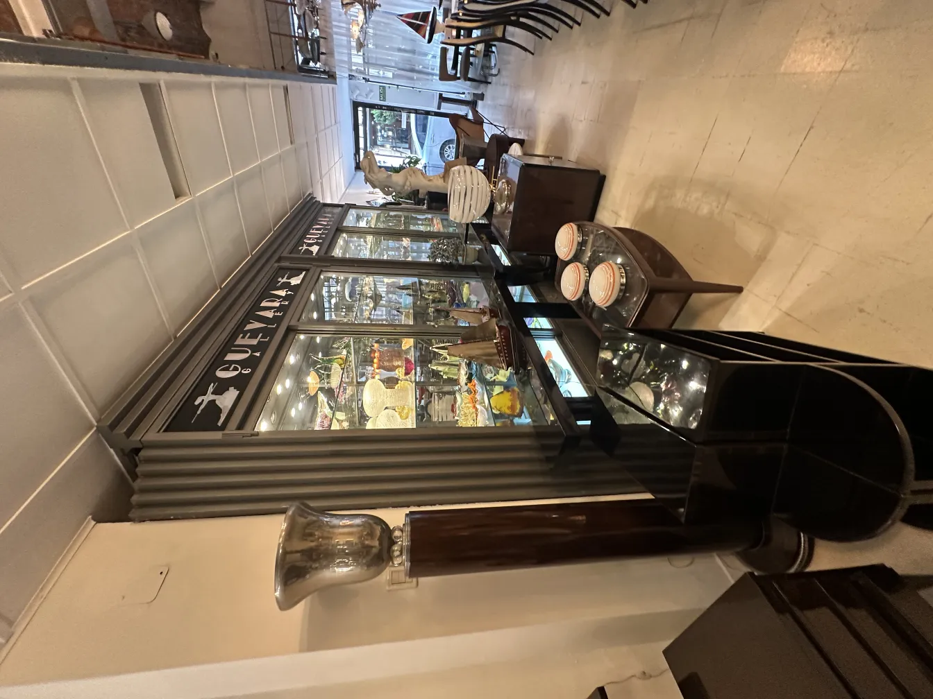 Luminária de pé antiga elegante em um ambiente com vitrines e móveis