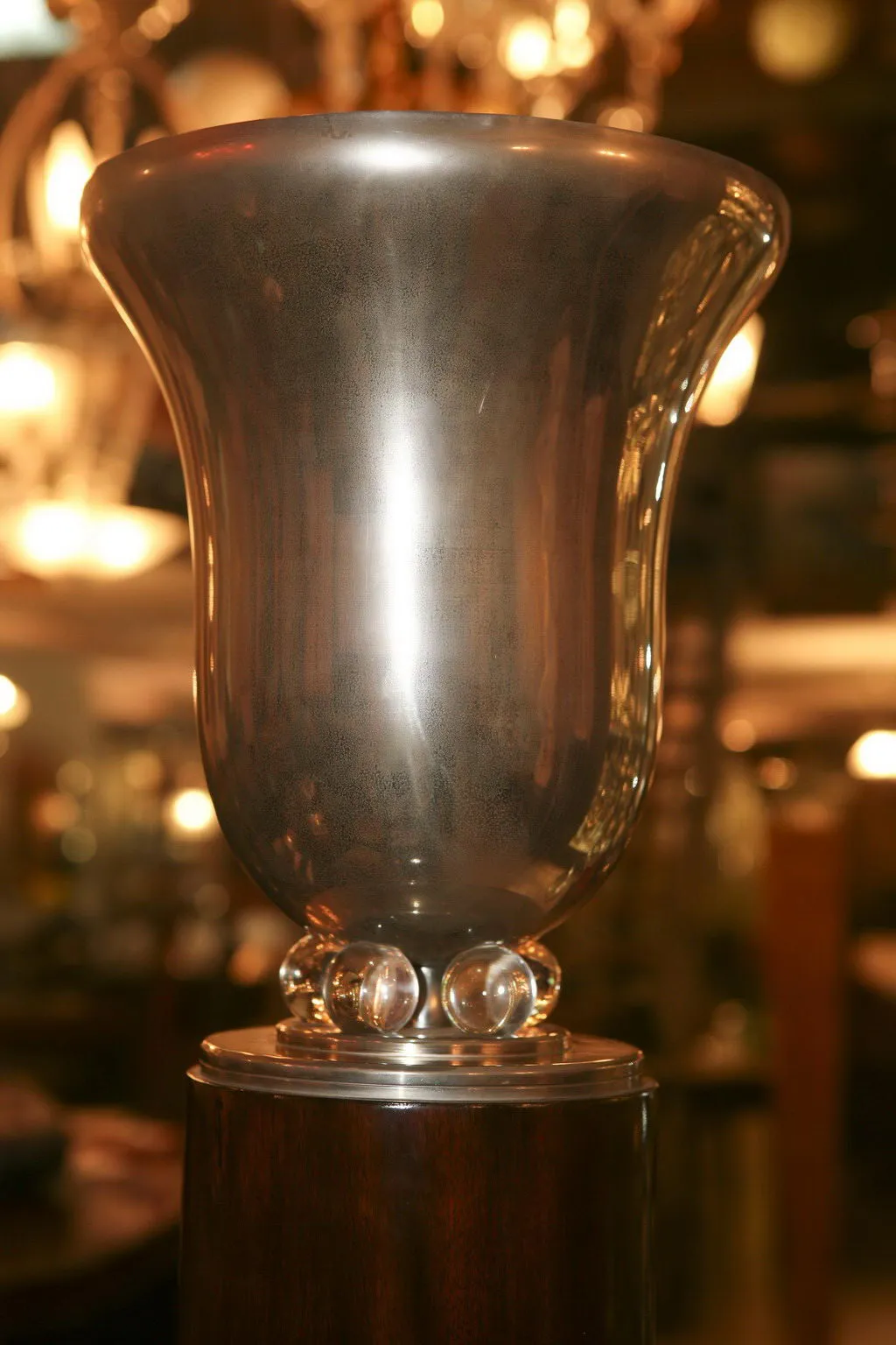 antique floor lamp with elegant shape and shiny detail, blurred background