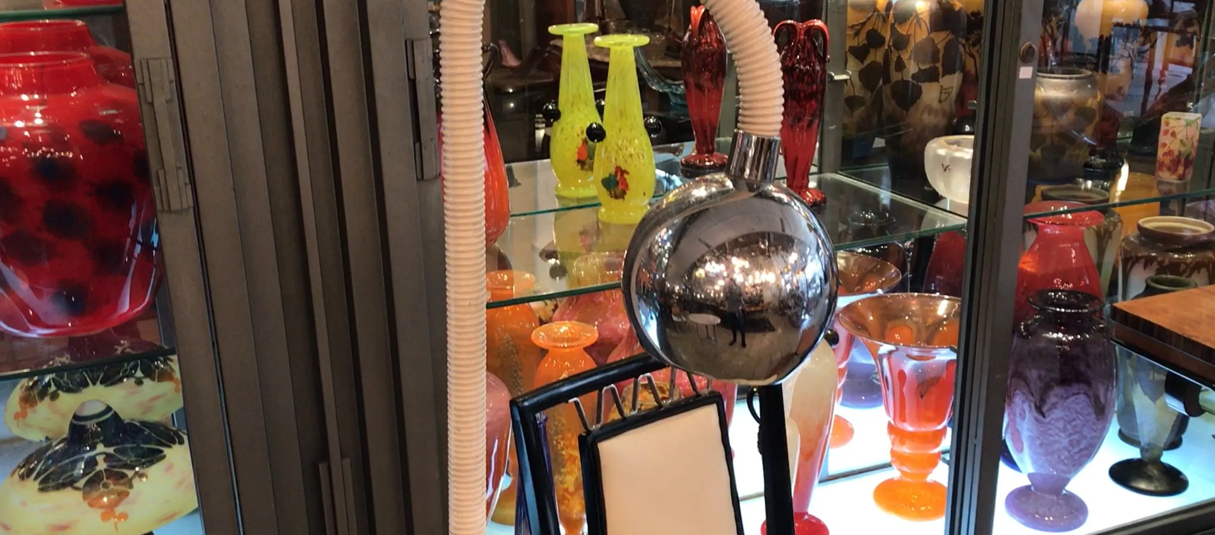 Antique floor lamp with a spherical design and colorful decor.